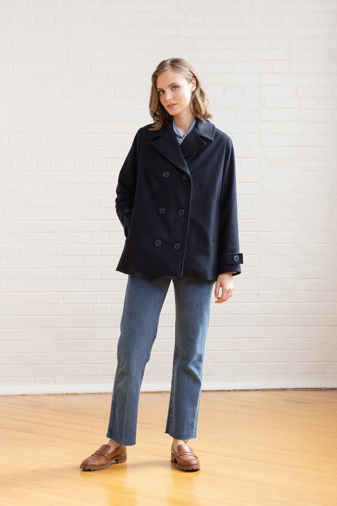 Woman wearing navy Maple peacoat