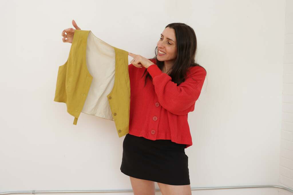 Sarai holding up the vest with finished lining