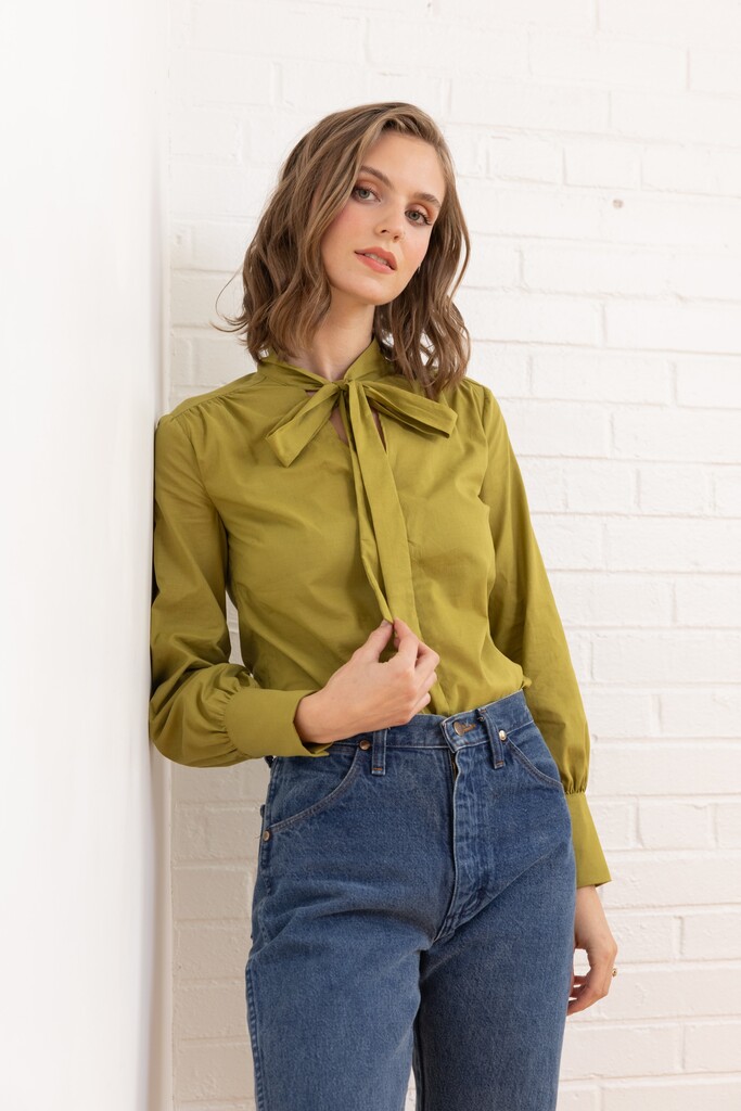 Woman wearing green member bonus Garnet blouse