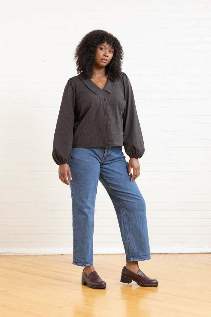 Woman wearing brown Cosmo blouse