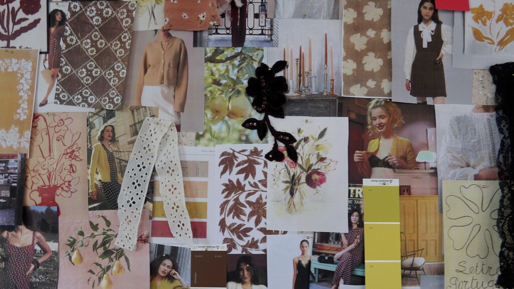 overhead shot of mood board with fabric swatches, inspiration photos, and pattern pieces laid out on a table